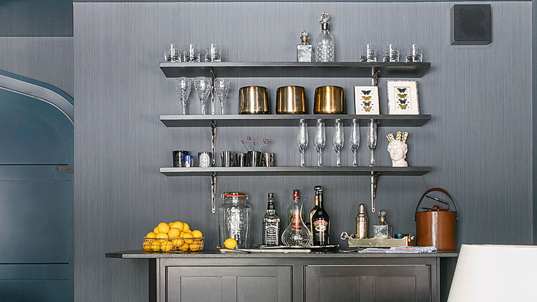 Stylish home bar setup with whiskey bottles, wine glasses, and elegant drink display at home”